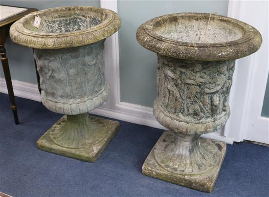 A pair of reconstituted stone campana-shaped urns with classical figures in relief, H 85cm W.63cm